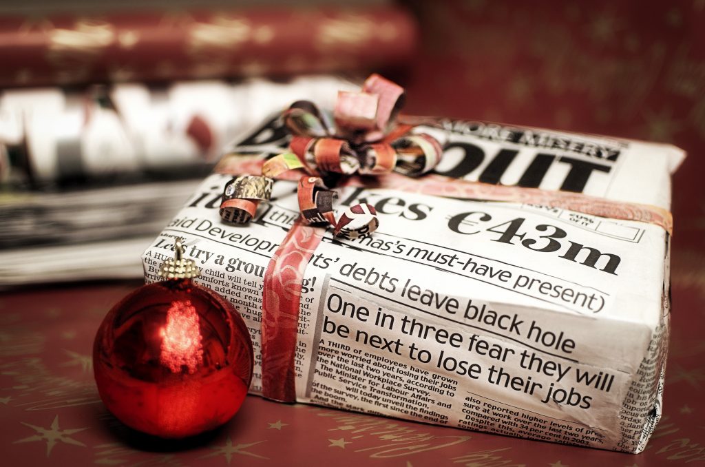 Christmas gift wrapped in newspaper.