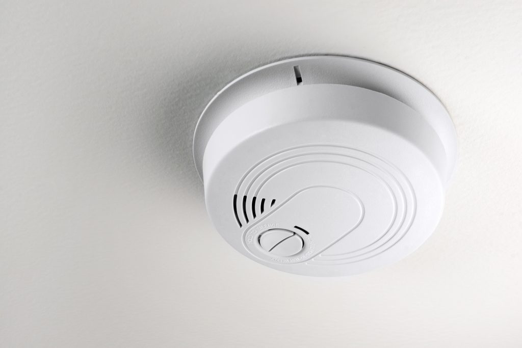 A smoke detector installed on a ceiling